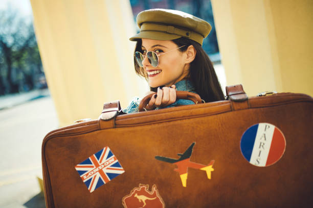 istock Traveler with sunglasses holding suitcase 1183408136