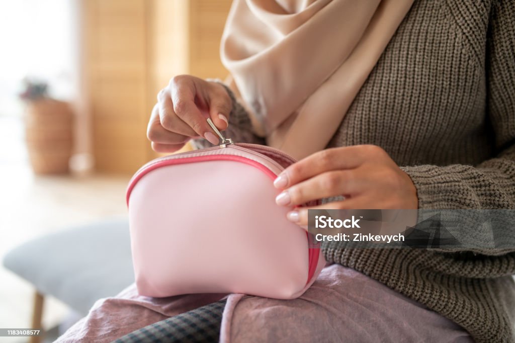 Top view of makeup cosmetic bag for woman Cosmetics bag. Top view of little pink makeup cosmetic bag for woman in her hands Make-Up Bag Stock Photo