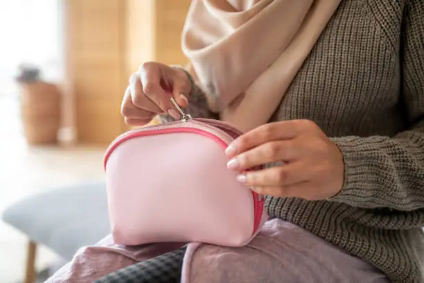 Cosmetics bag. Top view of little pink makeup cosmetic bag for woman in her hands