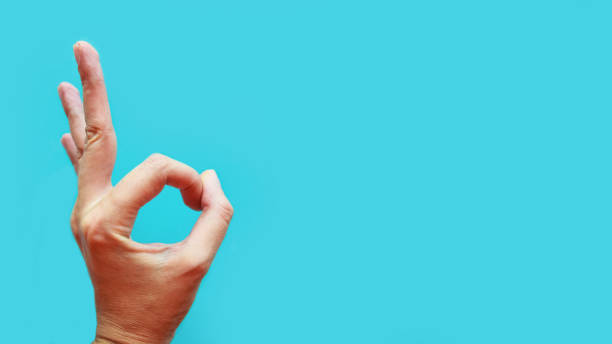 istock Hand ok sign over blue background, copy space 1183409496