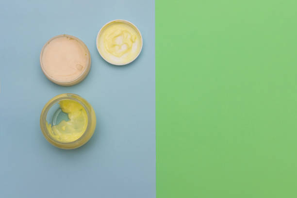 istock Cosmetic creams flat lay on colored background. 1183411170