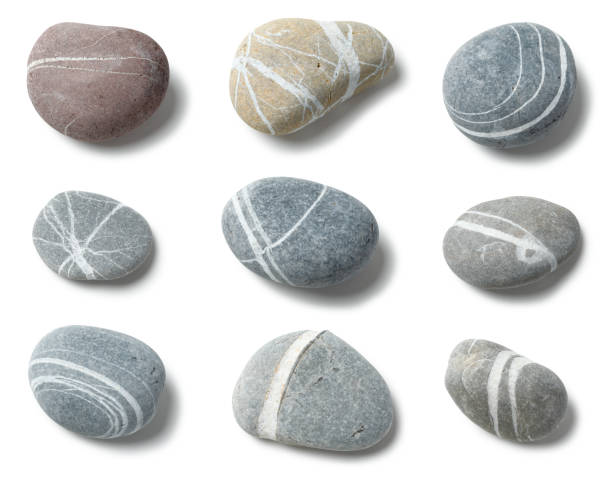 Grey Pebbles with expressive Lines Arranged pebbles isolated on white with clipping path spiral rock stock pictures, royalty-free photos & images