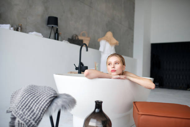 istock Blonde woman enjoying the moment while having bath 1183418369