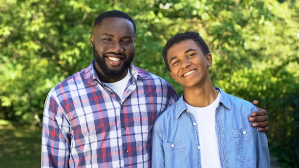 istock Cheerful black dad and son smiling on camera, trustful relations, friendship 1183419314