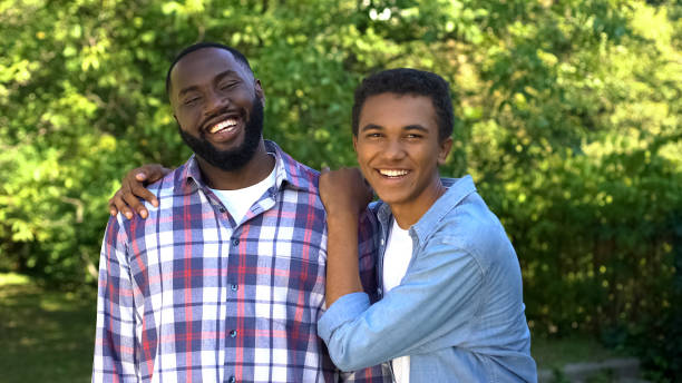 istock Joyful american brothers smiling on camera outdoors, family connection, fun 1183419323