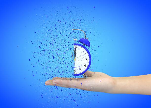istock Alarm clock blue on a blue background explodes in the girl's hands 1183423060