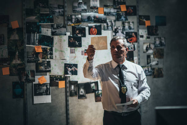 istock Mature detective examining evidences 1183423529