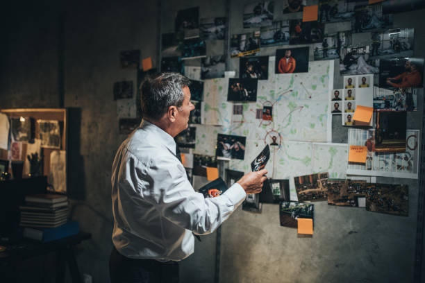 istock Mature detective examining evidences 1183423850