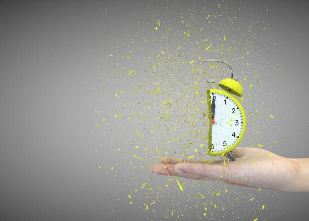 istock Alarm clock yellow on a gray background explodes in the girl's hands 1183423962