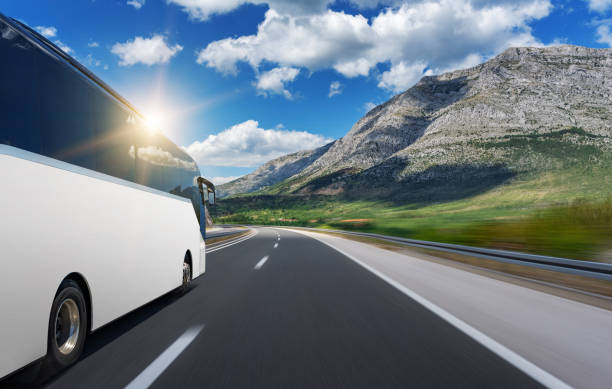 istock Unbranded white bus rushes along a highway. 1183424243
