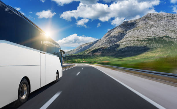 istock Unbranded white bus rushes along a highway. 1183424249