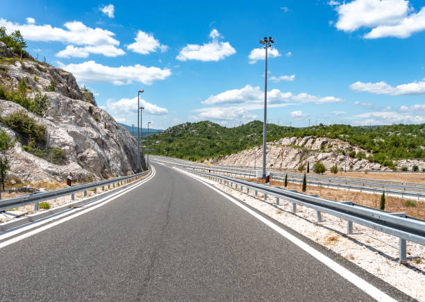 istock High-speed highway in mountainous terrain. 1183424293