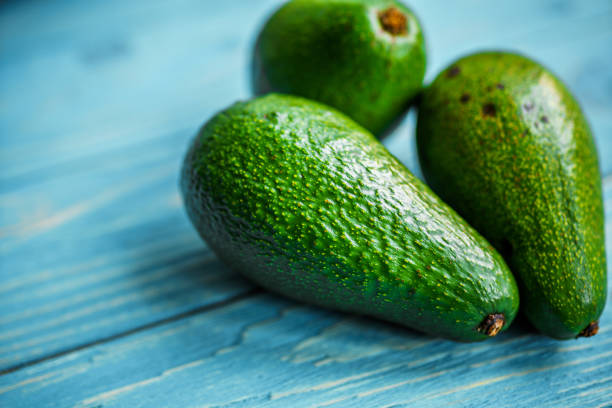 istock Avocado on wooden background 1183424532