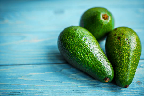 istock Avocado on wooden background 1183424534