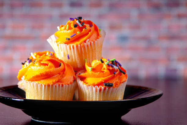 istock Halloween muffins on a black plate with a brick background 1183425869