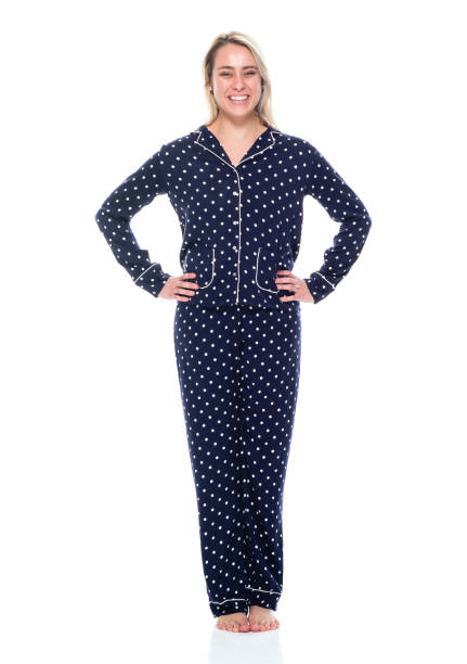 full length / front view / looking at camera / one person of 20-29 years old adult beautiful blond hair / long hair caucasian female / young women standing wearing pajamas / nightwear who is smiling / happy / cheerful / laughing / successful - one young woman only only young women one woman only 20 25 years imagens e fotografias de stock