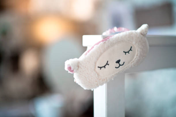 istock Sleep mask hanging on a bed in bedroom 1183426207