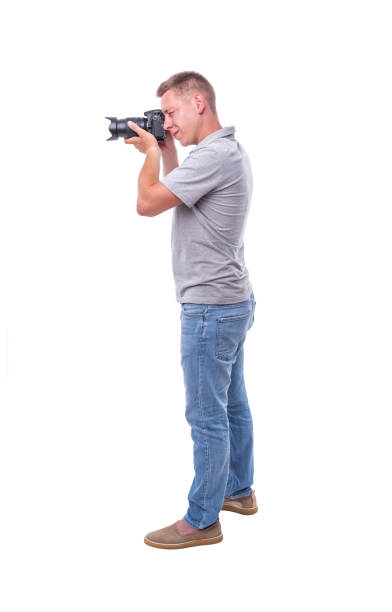 istock The photographer with the camera on white. 1183427879