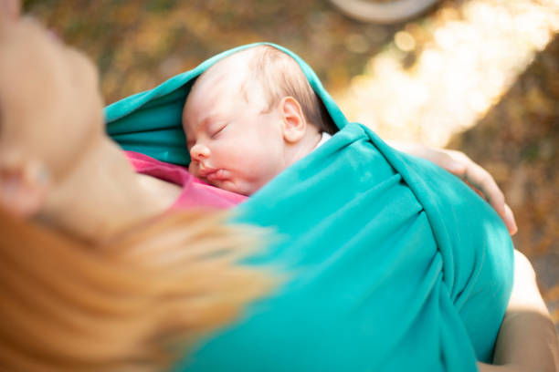 istock Newborn sleeping in baby carrier 1183428532