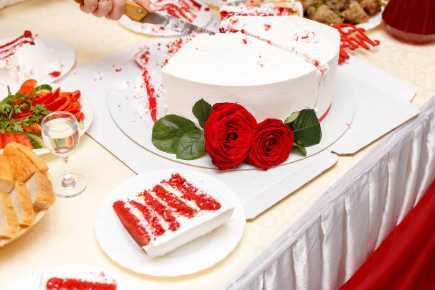 istock cutting wedding cake decorated with roses 1183432387