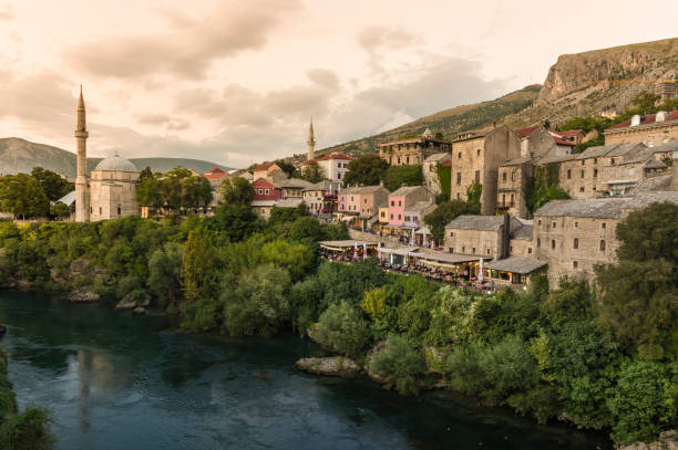 Koski Mehmed Pasha Mosque sunset in Mostar Bosnia Herzegovina The view of Mostar’s Koski Mehmed Pasha Mosque from the old bridge showing the mosque stari most mostar stock pictures, royalty-free photos & images