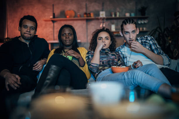 istock Multi-ethnic friends watching TV 1183436010