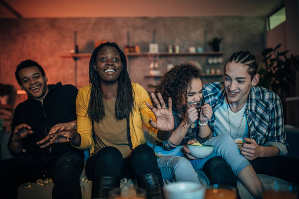 istock Multi-ethnic friends watching TV 1183436075