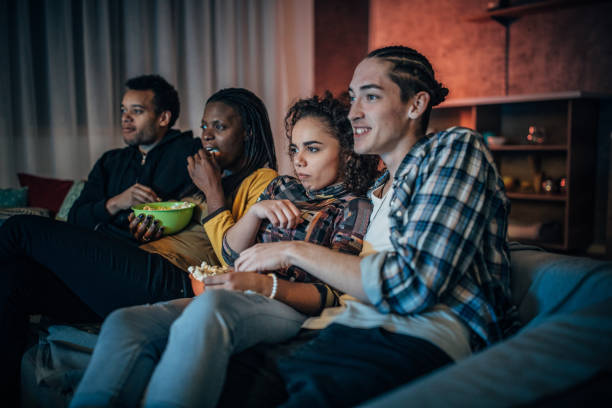 istock Multi-ethnic friends watching TV 1183436115