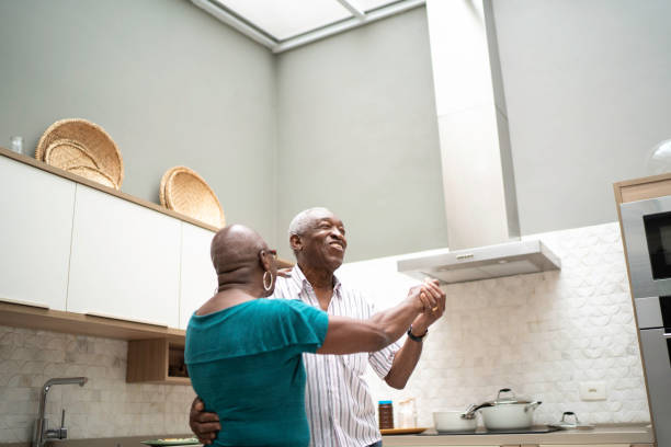 istock Senior couple dancing at home 1183438573