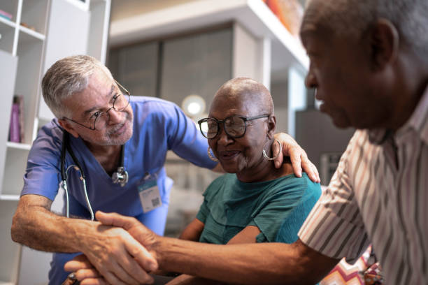 medico che saluta una coppia di anziani - nursing home senior adult group of people home caregiver foto e immagini stock
