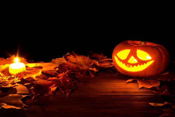 istock Halloween pumpkin with dry maple leaves. 1183441346
