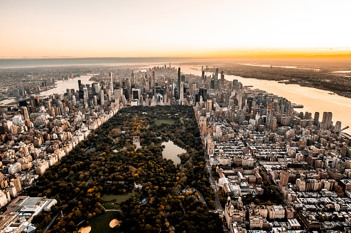 Golden hour photo of a Central Park in downtown NYC taken from air.