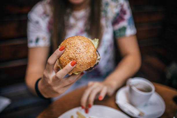 istock Woman  Eating  Burger 1183442213