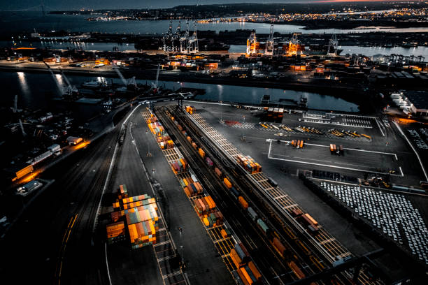 aerial view of the new jersey shipyard with numerous cranes, gantries and shipping containers, captured at golden hour - warehouse distribution warehouse crate box imagens e fotografias de stock
