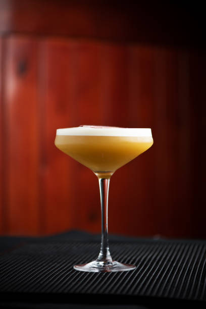 istock cocktail with passion fruit in tall glass on brown background bar 1183442389