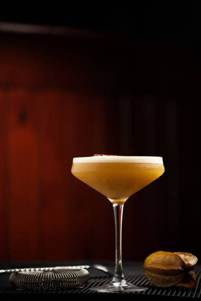 istock cocktail with passion fruit in tall glass on brown background bar 1183442413