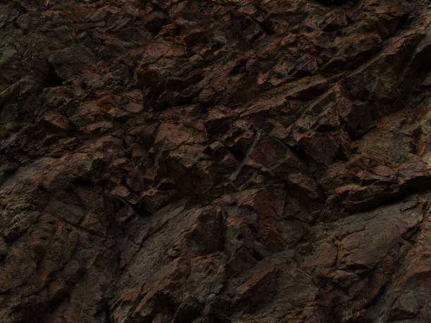 istock rock, texture, black, abstract, background, stone, grunge, closeup, dark, brown,  wall, surface, backdrop, mountain, volcanic, granite, formation, rough, art, design, blank, bright, cliff, color, red, colorful, copy space, pattern, crack, detail, fragment 1183444326
