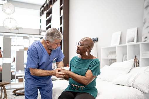 Doctor consoling a patient, holding hands