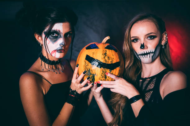 istock Two Halloween girls with pumpkin 1183446070