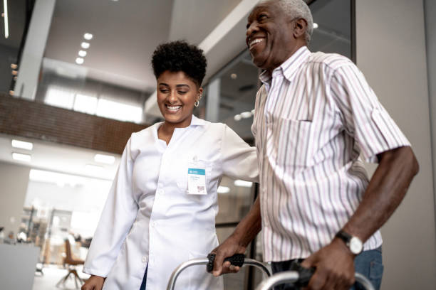istock Caretaker assisting senior man with walker 1183448049