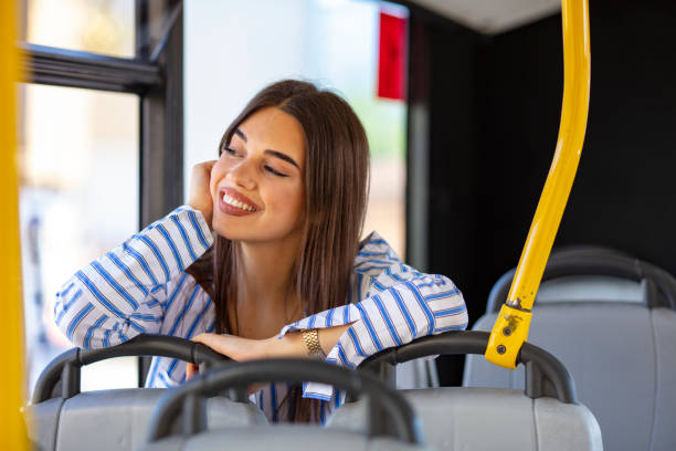 istock Young woman taking bus to work 1183448384