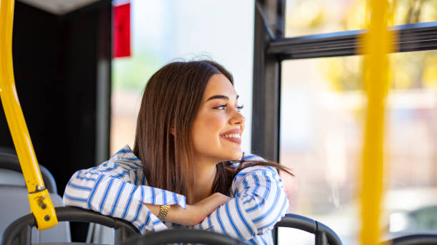 istock Young lady on commute travel to work sitting in bus or train 1183448459