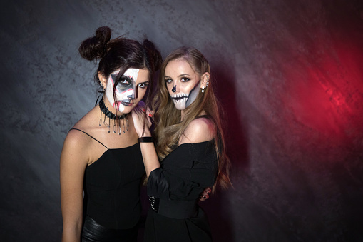 Two females on halloween wearing masks