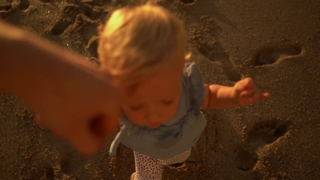 Slow motion video with little girl holding hand with her parent
