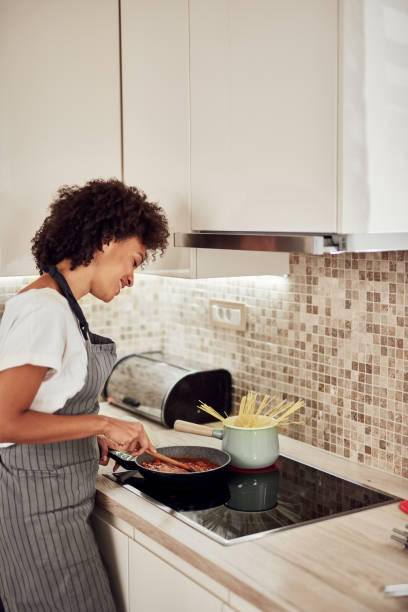 istock Woman stirring sauce. 1183453512