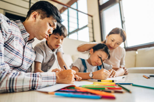 istock Family Filling a Coloring Book 1183453562