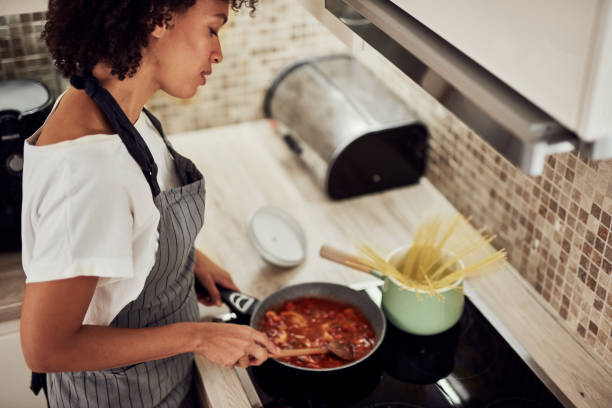 Woman stirring sauce. stock photo