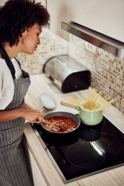 istock Woman stirring sauce. 1183454391