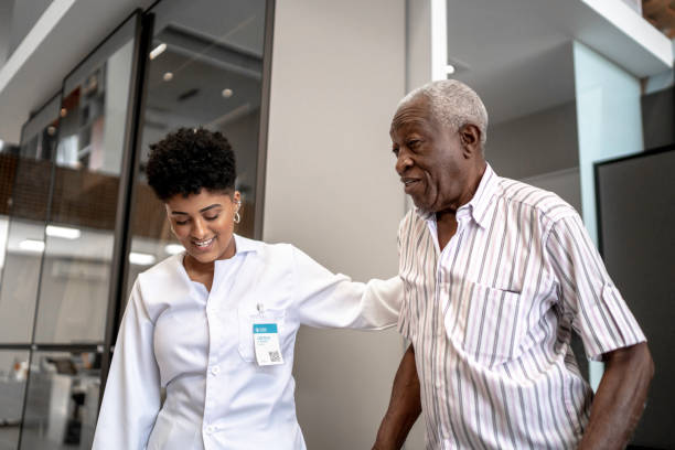 istock Caretaker assisting senior man with walker 1183454393