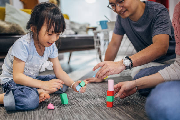 istock Family playing with blocks on the floor 1183454425